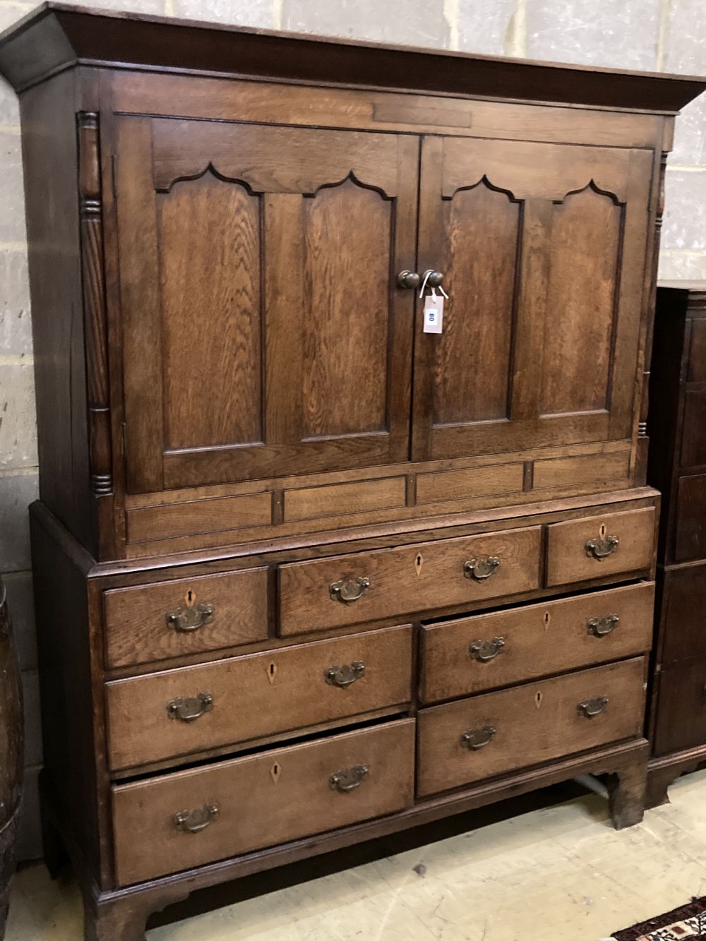 A George III oak housekeepers cupboard, width 138cm depth 52cm height 174cm